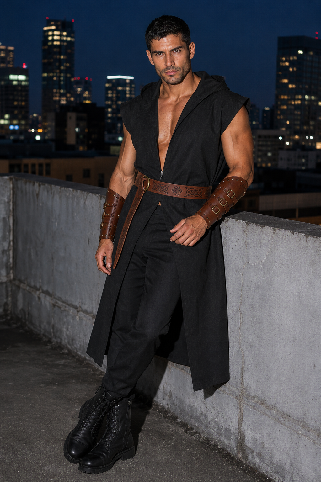 A muscular man wearing a black hooded sleeveless tunic with a brown leather belt and matching brown leather arm guards, posing on a rooftop at night with a city skyline in the background.