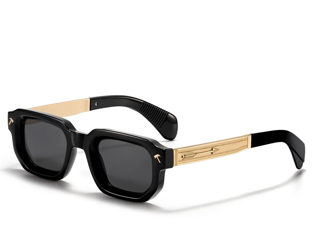 Sunglasses with black frames and gold accents on a white background, featuring the Caterside brand.
